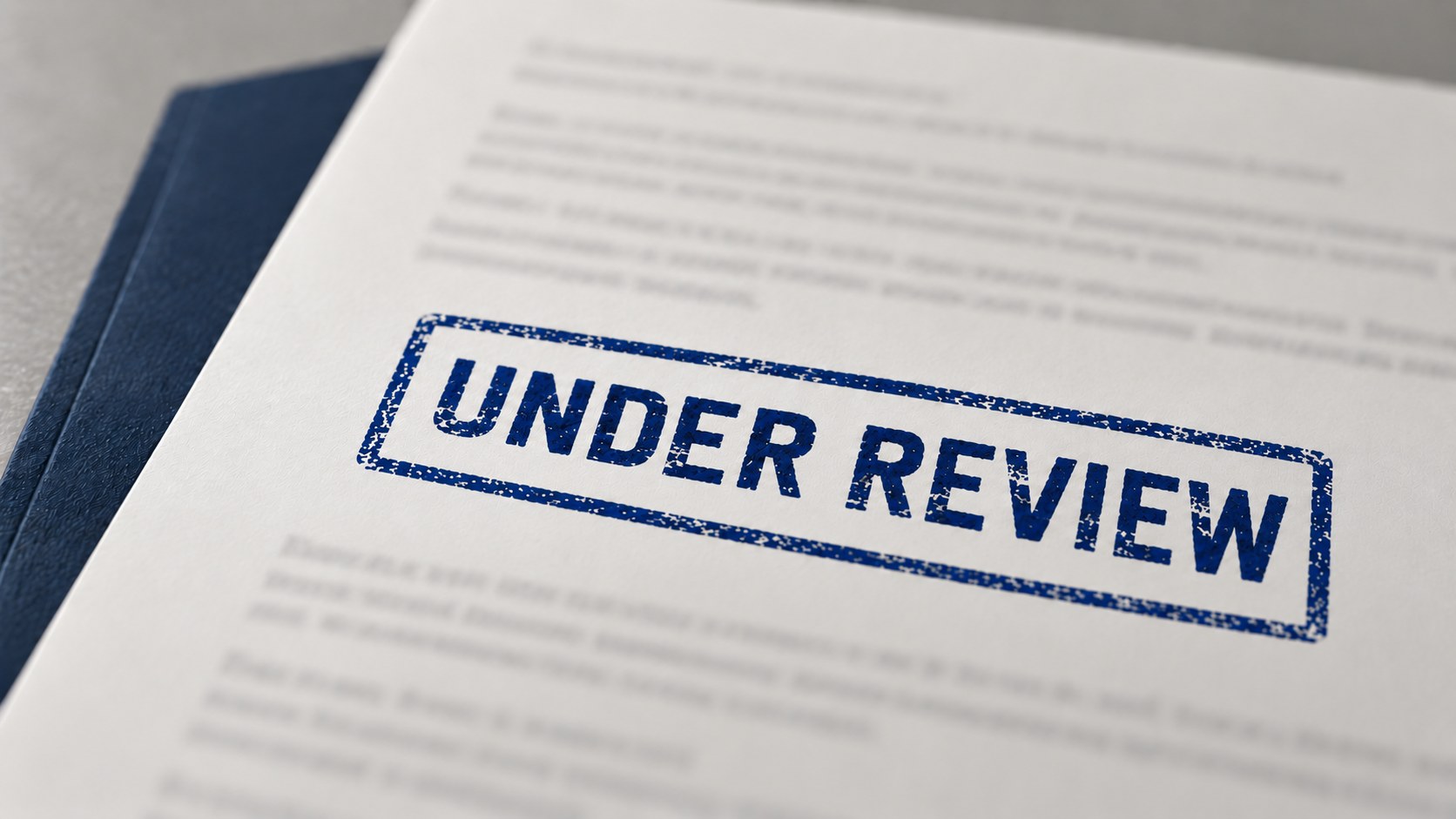Document stamped "Under Review" in blue ink